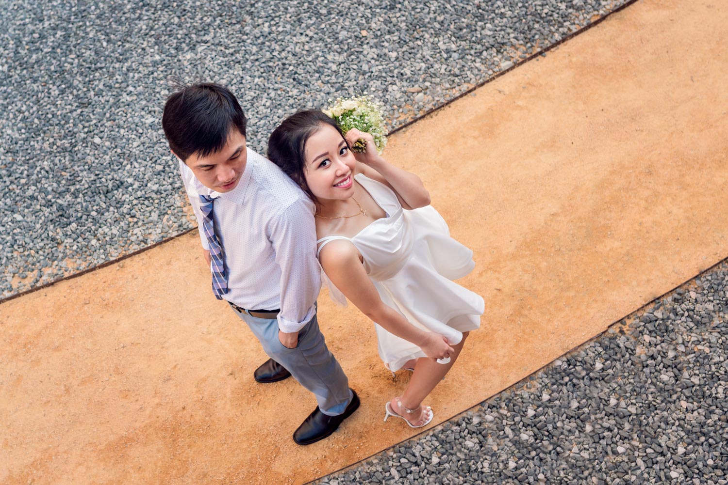 Couple leaning in the rock pave road