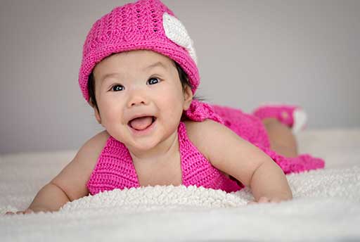 Pink baby dress laydown portrait