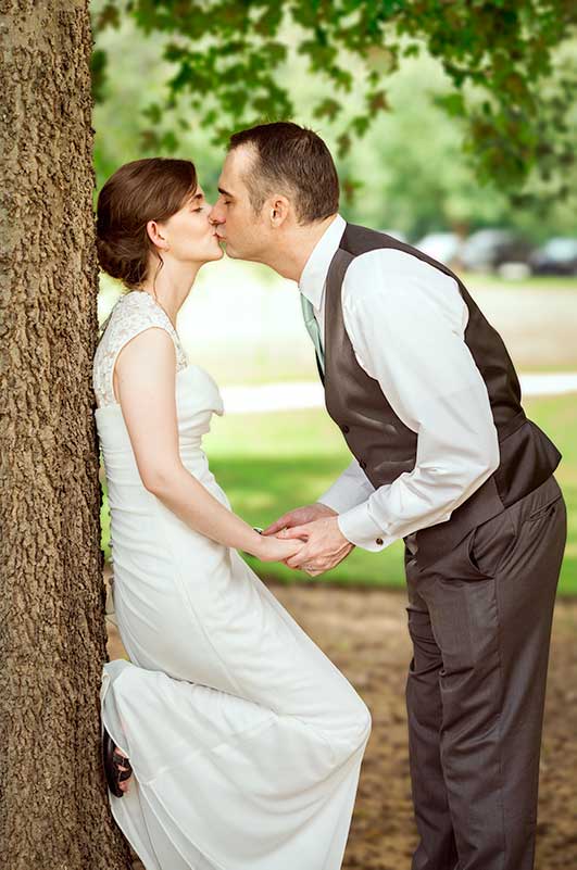 Groom bend down and kiss the bride