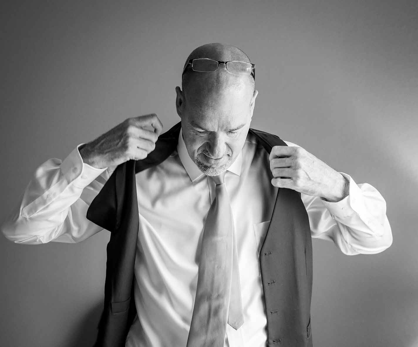 Groom adjusting attire before wedding